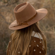 A wood brown hat with a flat brim.