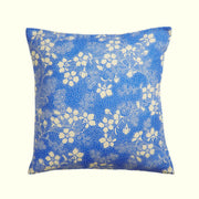 A blue floral print pillow. 