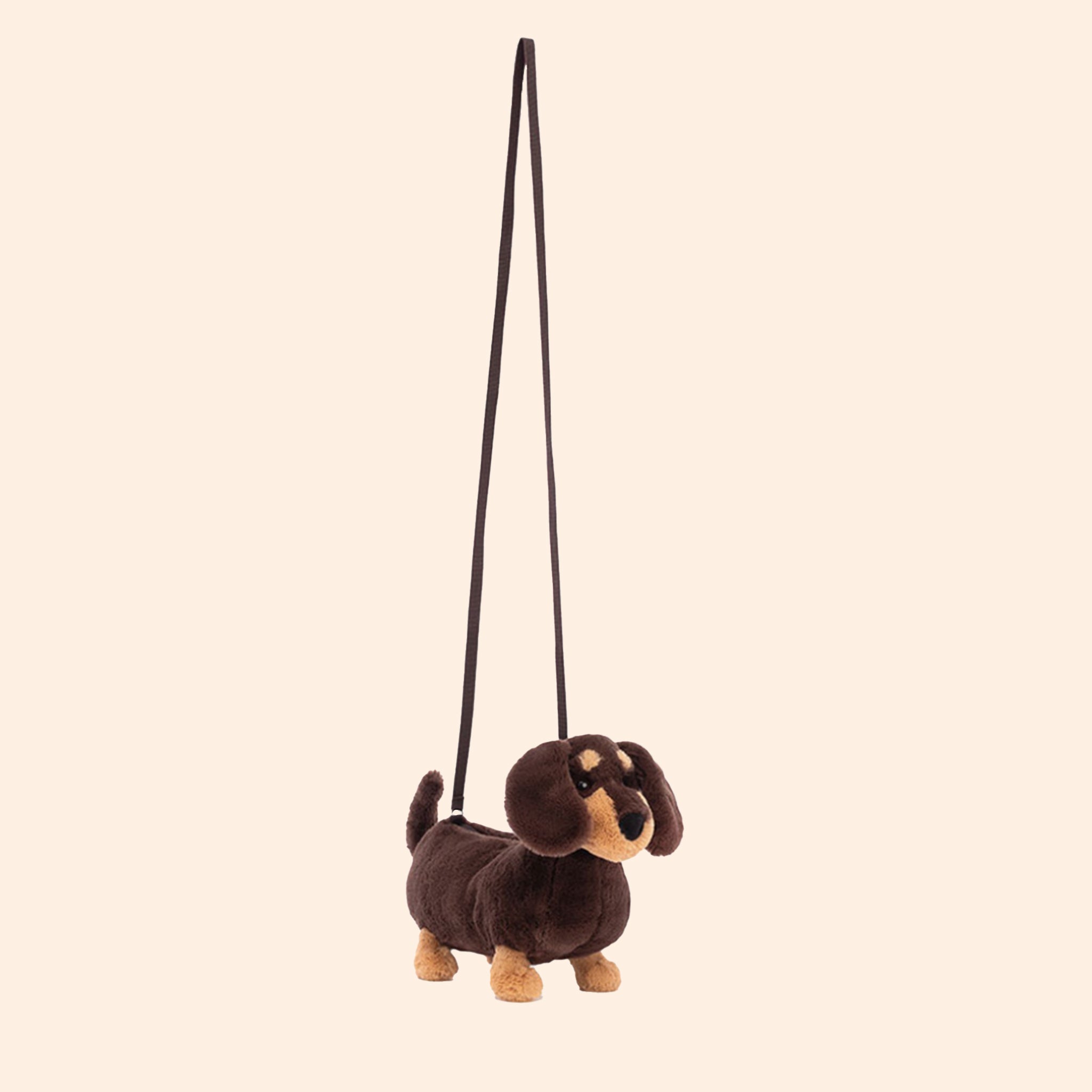 A brown and tan wiener dog stuffed toy bag with a zipper closure and a crossbody strap.