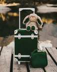 A dark green children's suitcase with white details. 