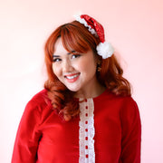 A model wearing the small Santa hat sequin headband. 