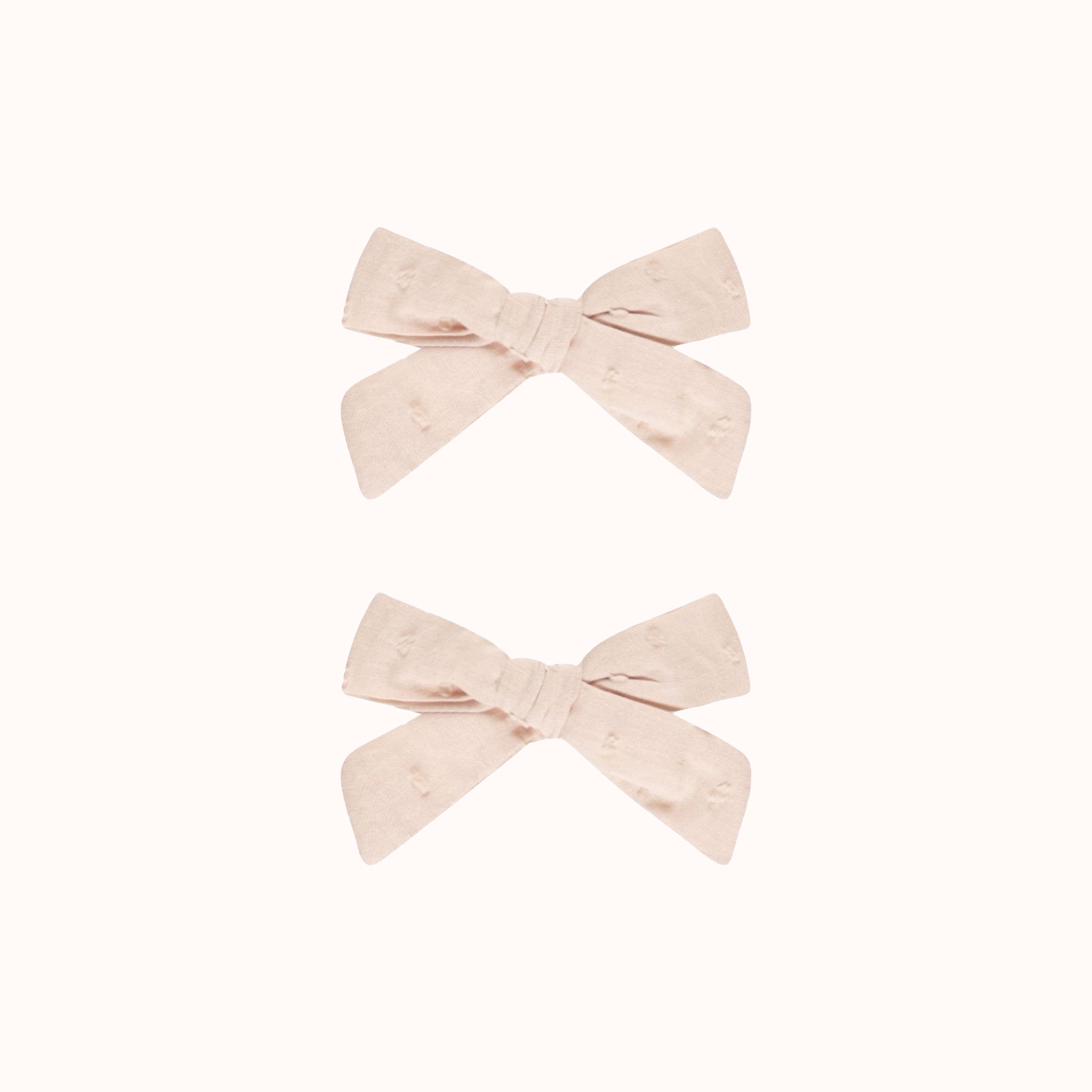 A set of two light pink hair bows. 