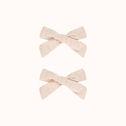 A set of two light pink hair bows. 