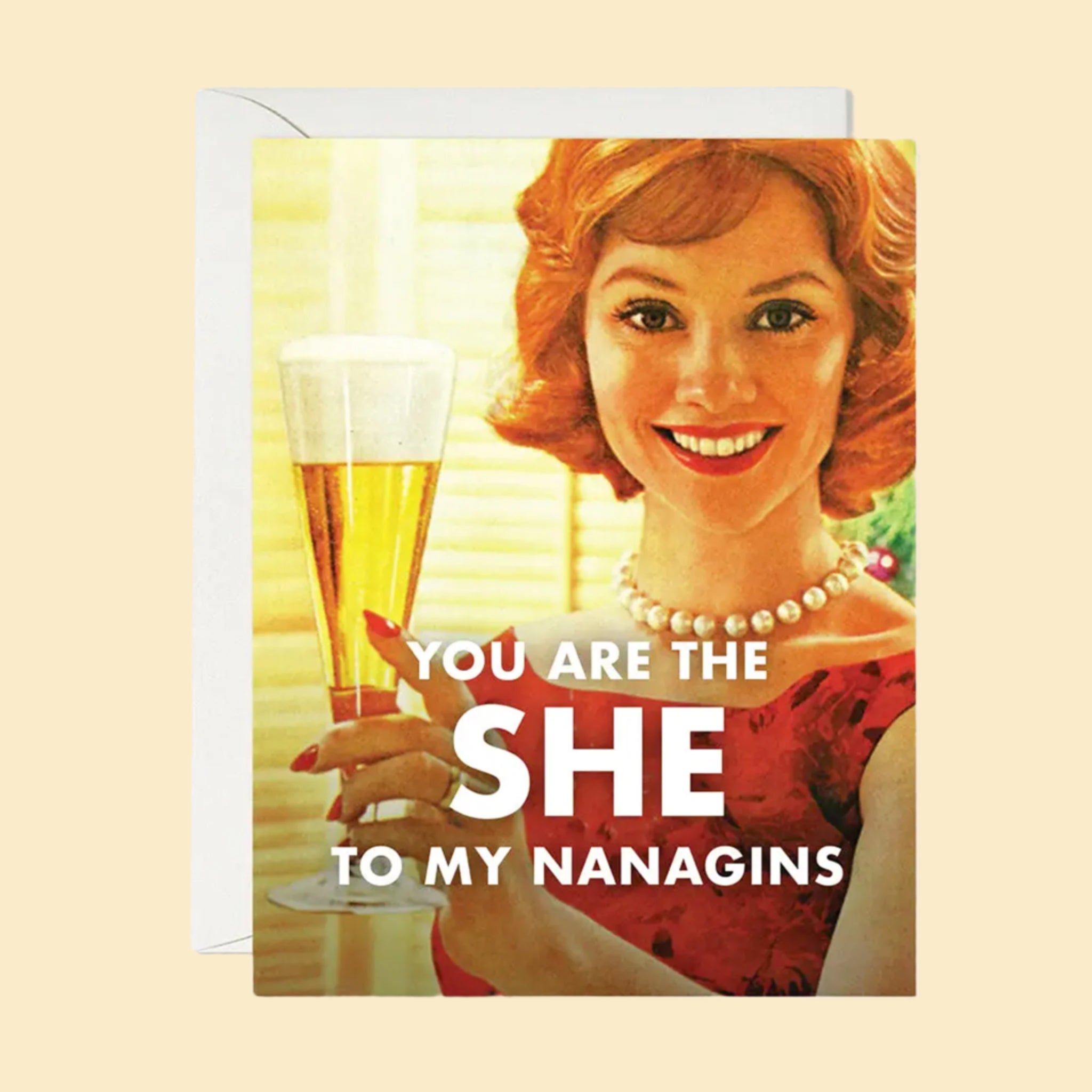 A card that reads, &#39;You Are The She To My Nanigans&#39; with a photo of a woman holding a glass of champagne. 