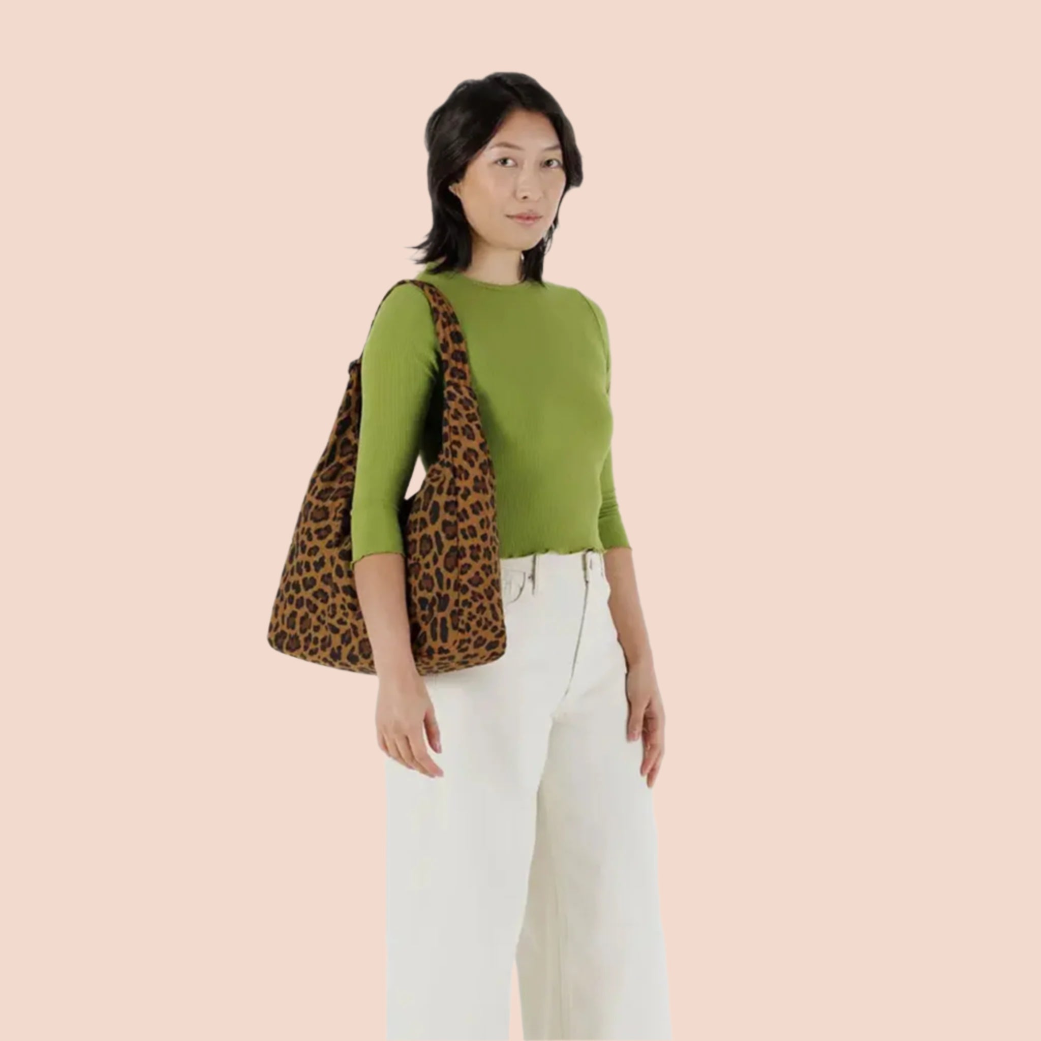 A nylon shoulder handbag with a leopard print pattern.