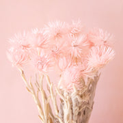 A light pink bundle of dried florals. 