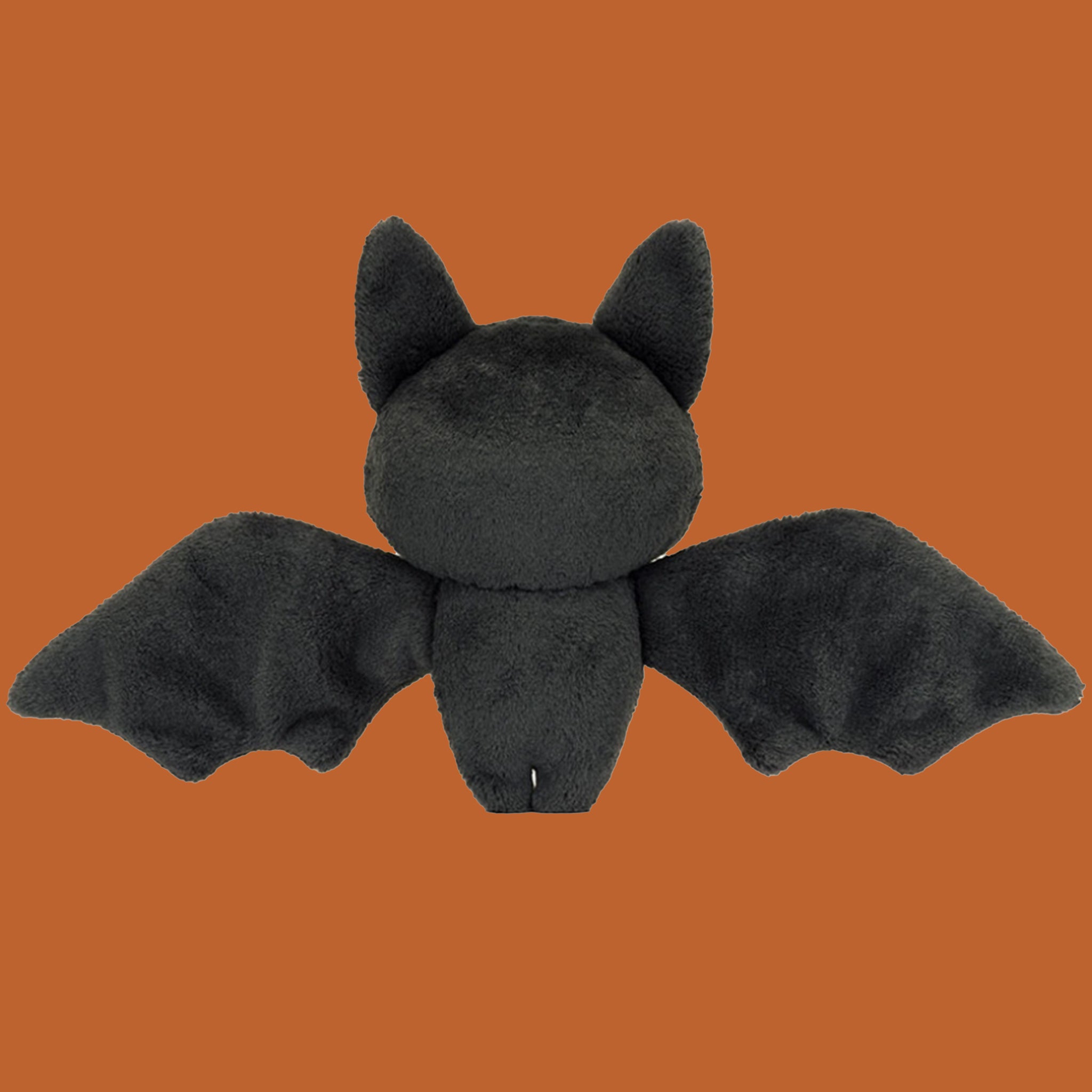 A black bat shaped skeleton stuffed toy.