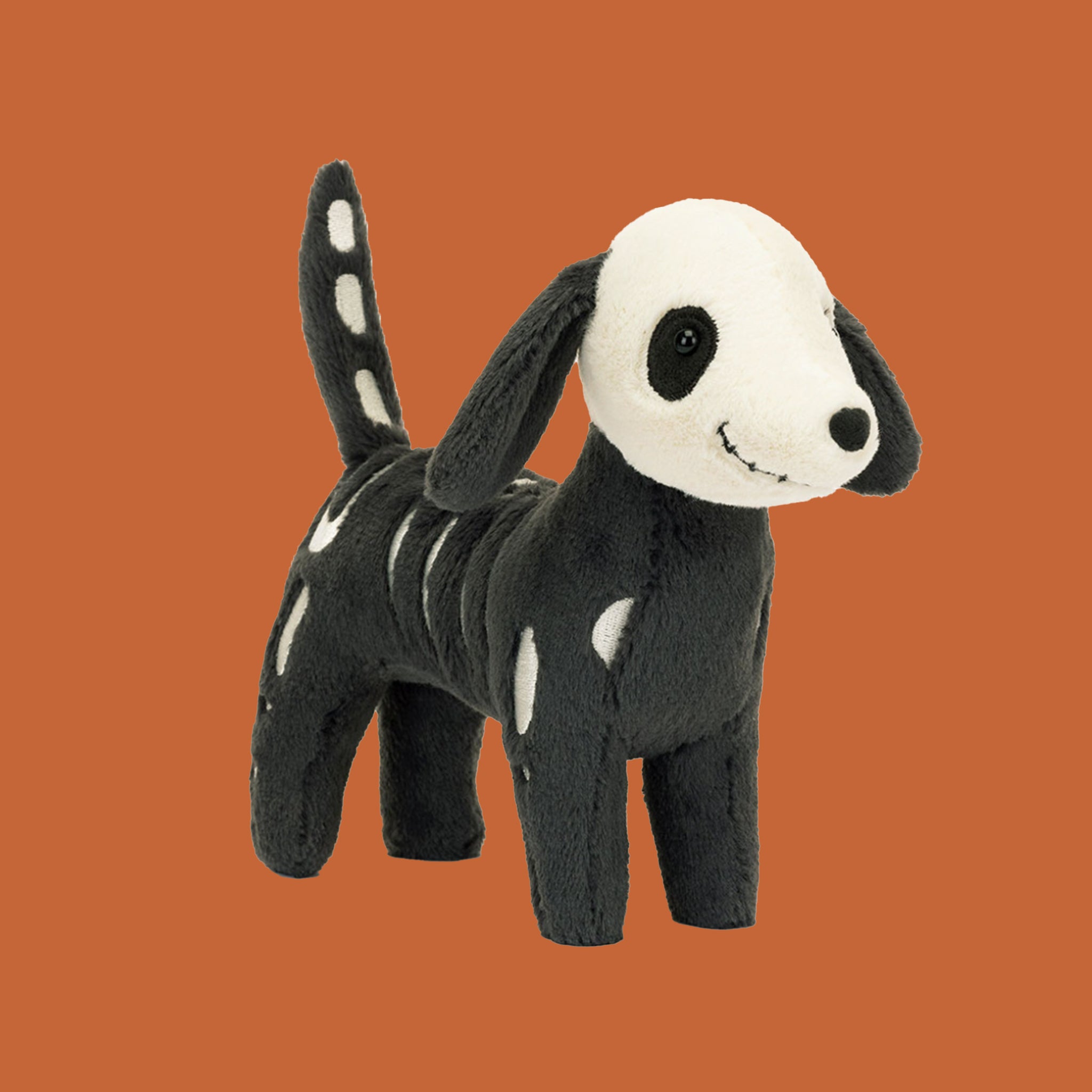 A black and white skeledog shaped stuffed toy.  