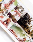 The book open to show the photographs of iconic women inside. 