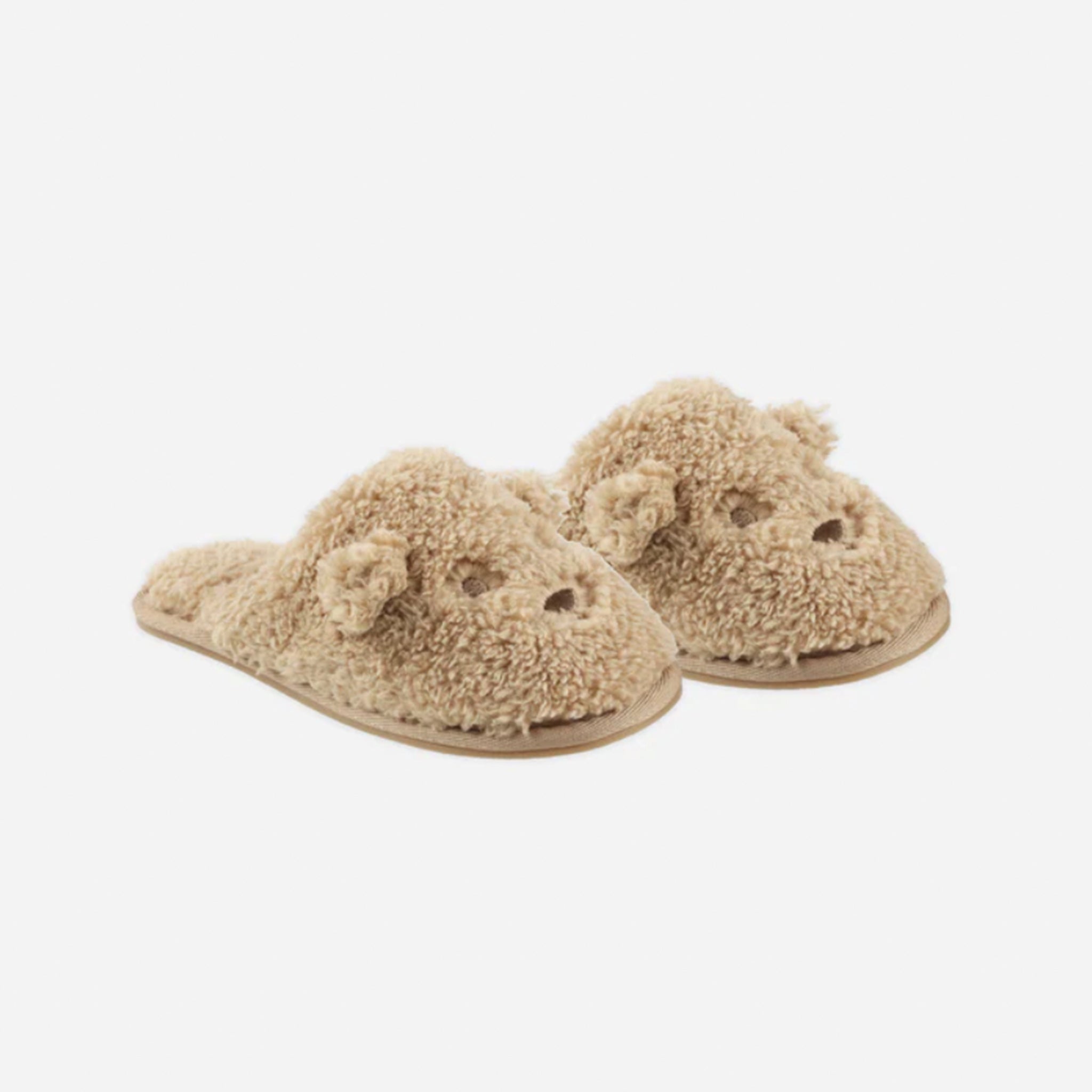 A pair of fuzzy brown slippers with a bear face design on the front. 