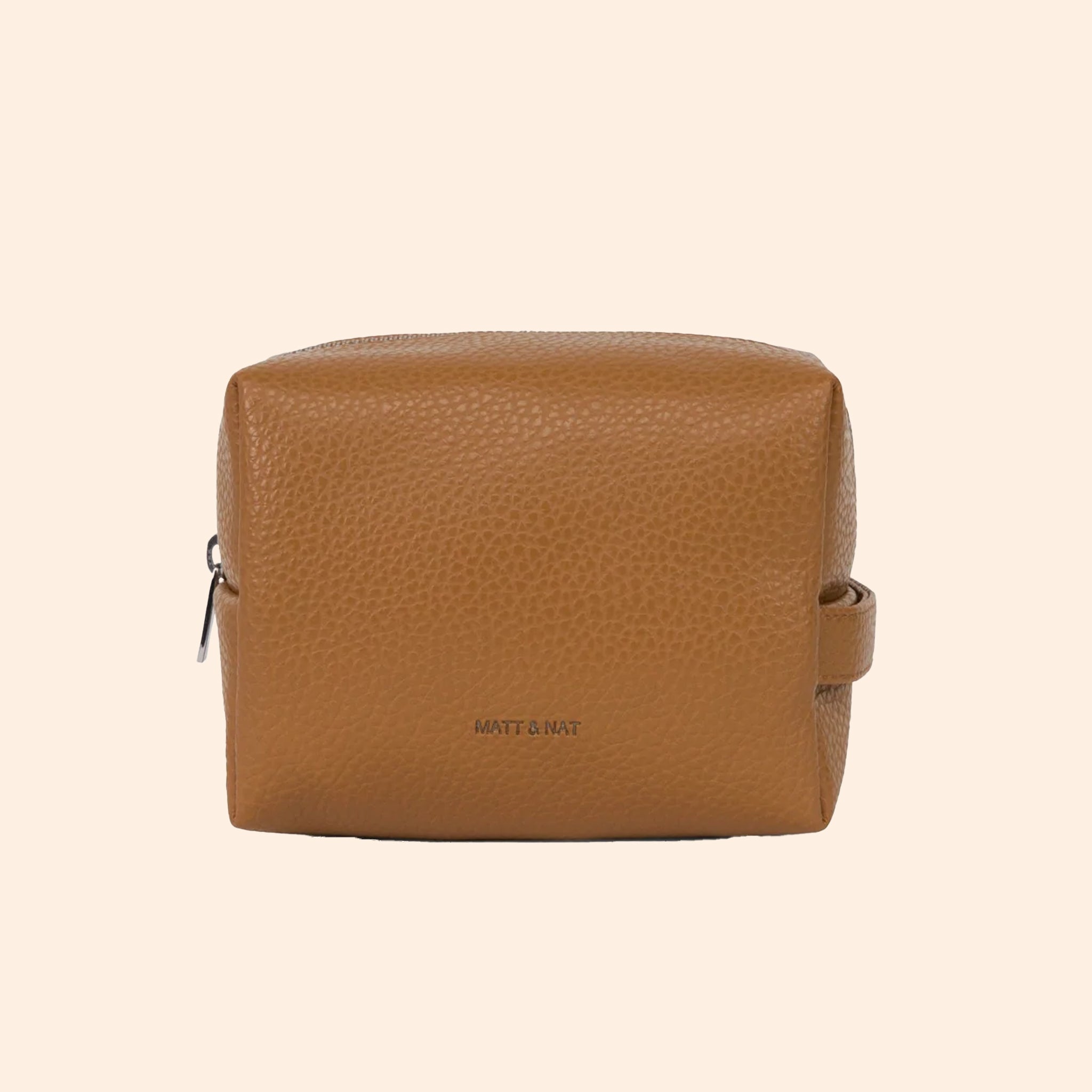 A warm brown toiletry case with a zipper closure. 