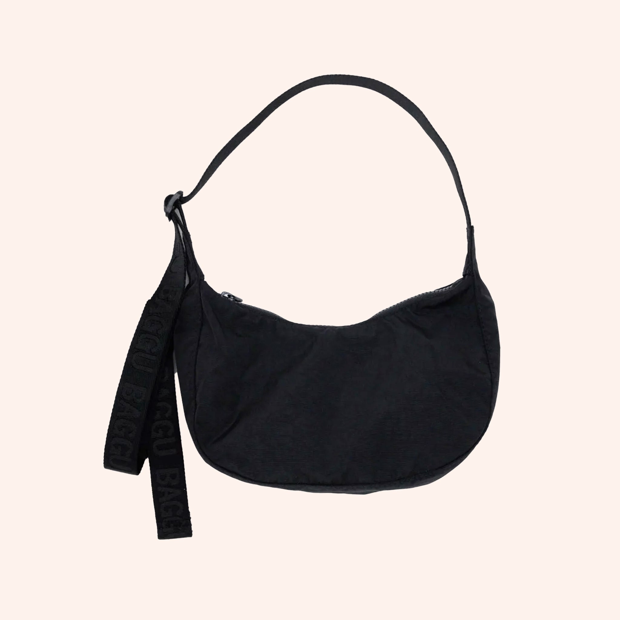 A small crescent shaped nylon shoulder bag with an adjustable strap to make it crossbody. 