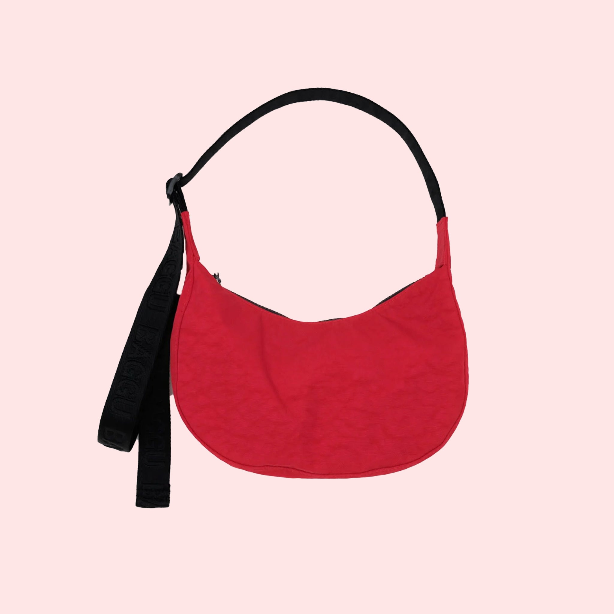 A small red nylon handbag with a back adjustable strap. 