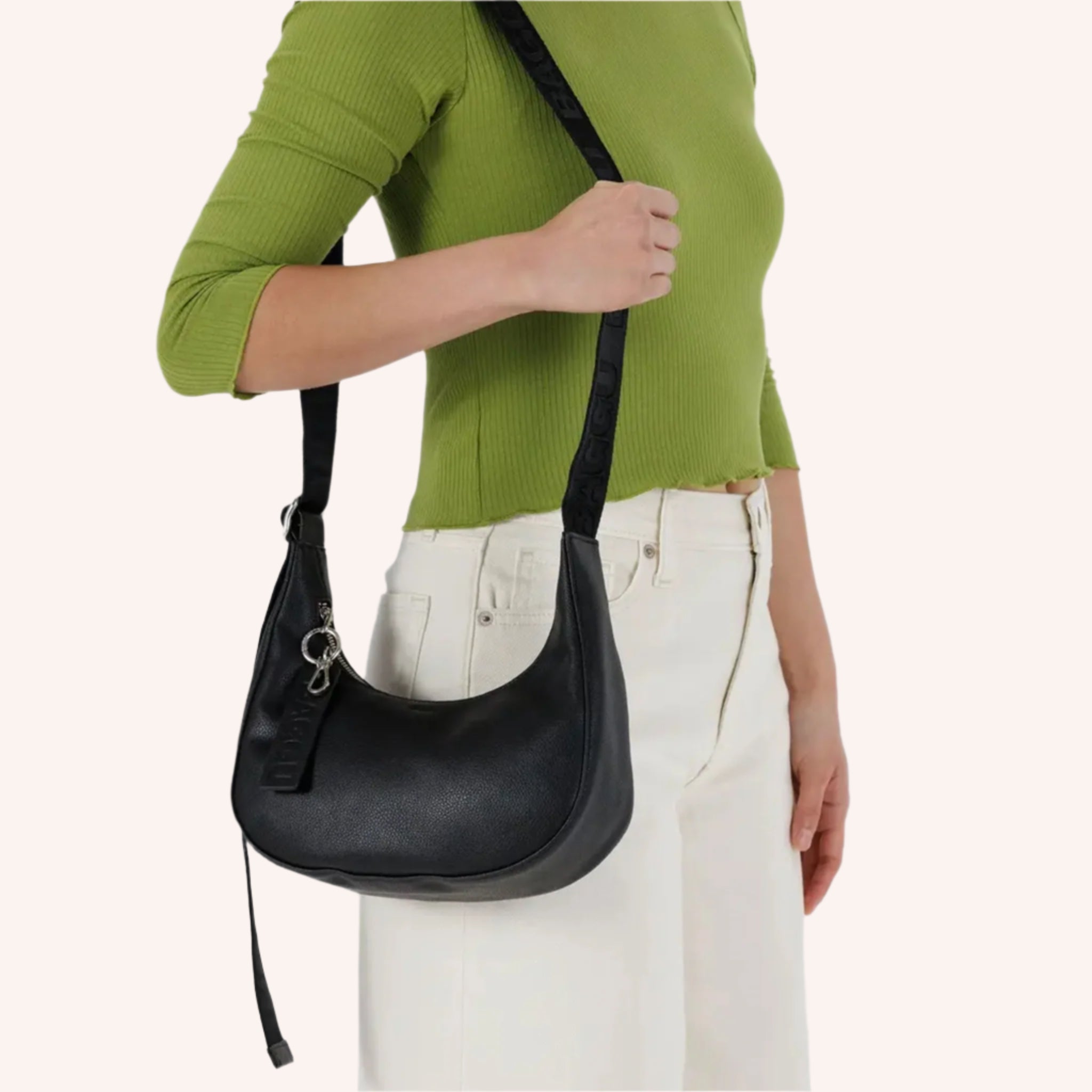 A black leather crescent bag handbag with an adjustable strap. 
