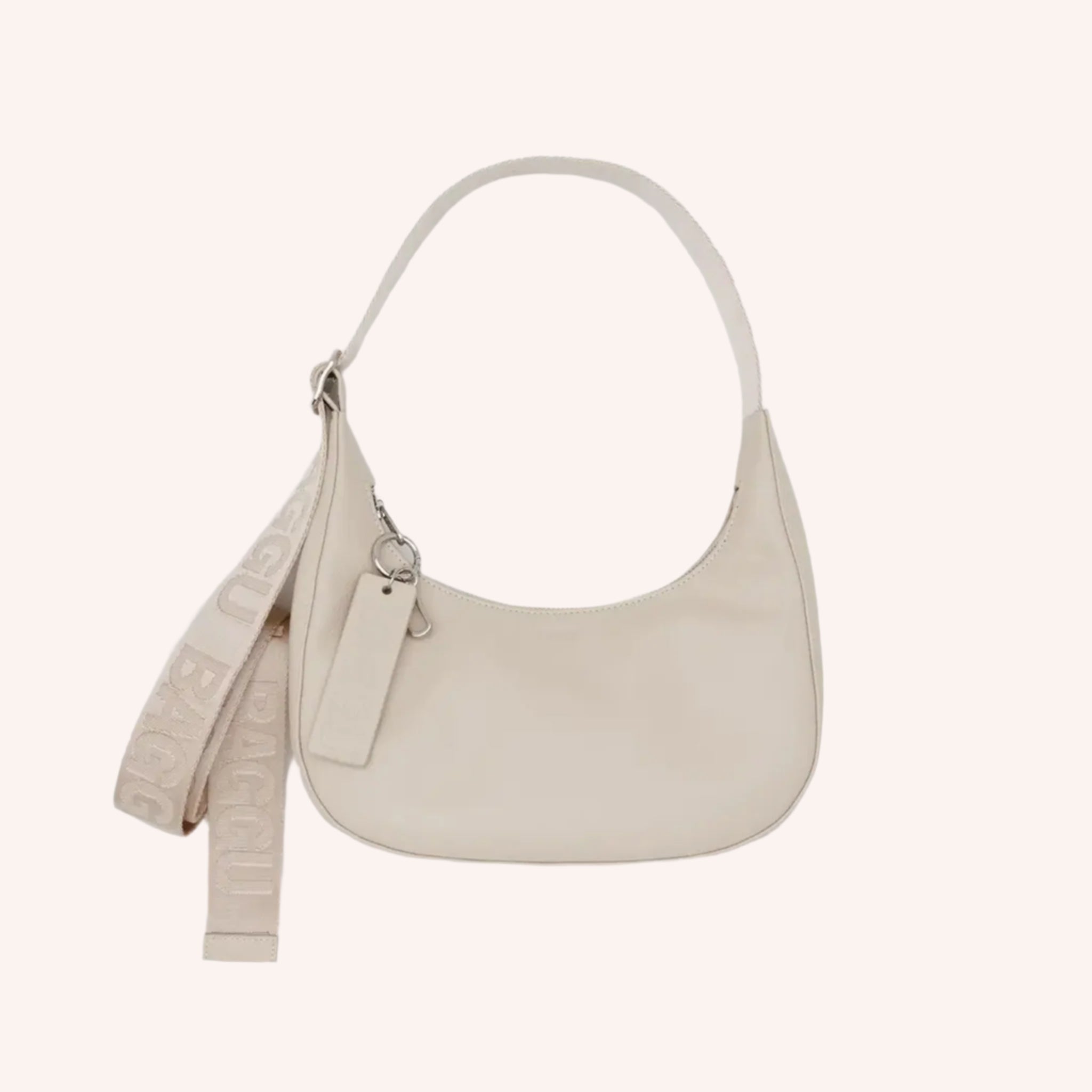 A small cream leather shoulder bag with an adjustable strap. 