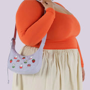 A light blue bag with a Miffy and mushroom design. 
