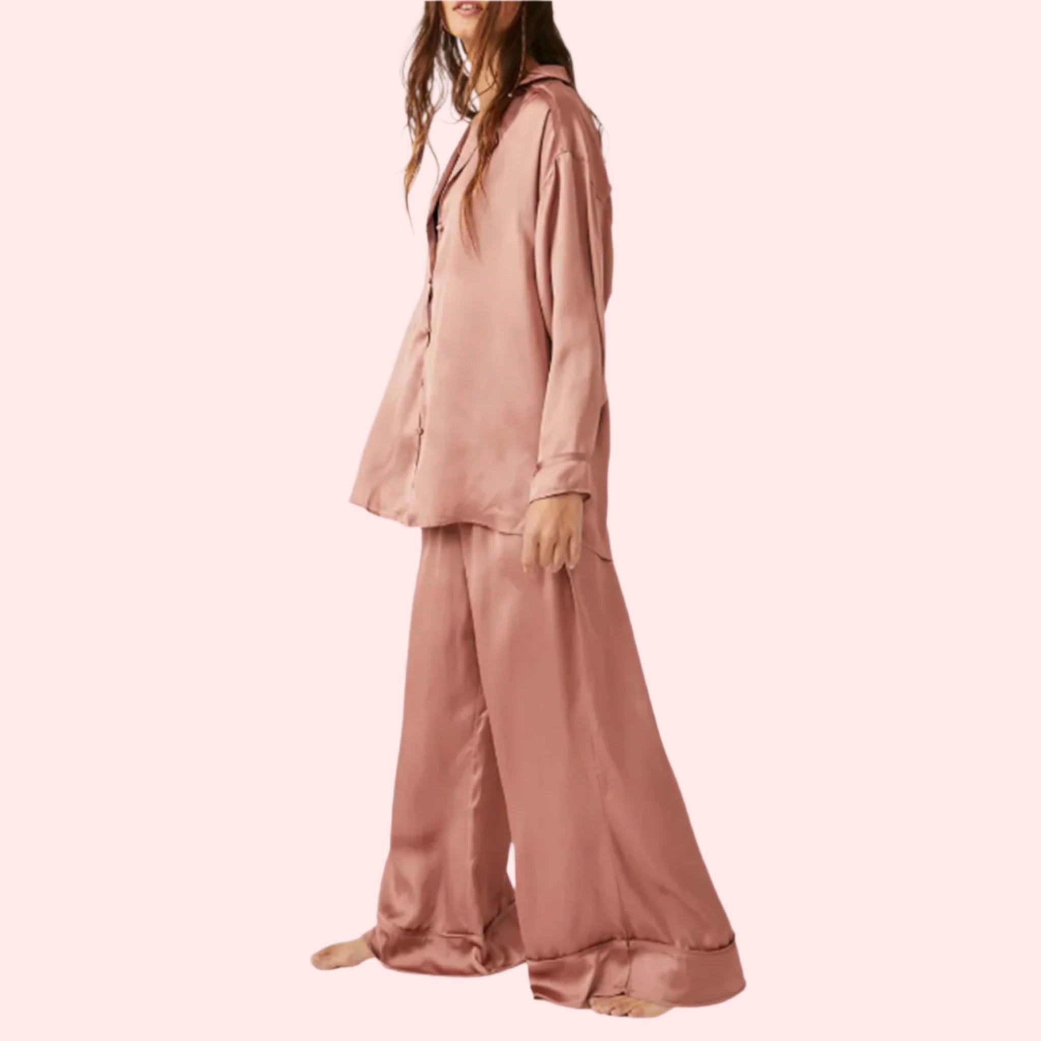 A model wearing an oversized slouchy fit pajama set in a rose gold color. 