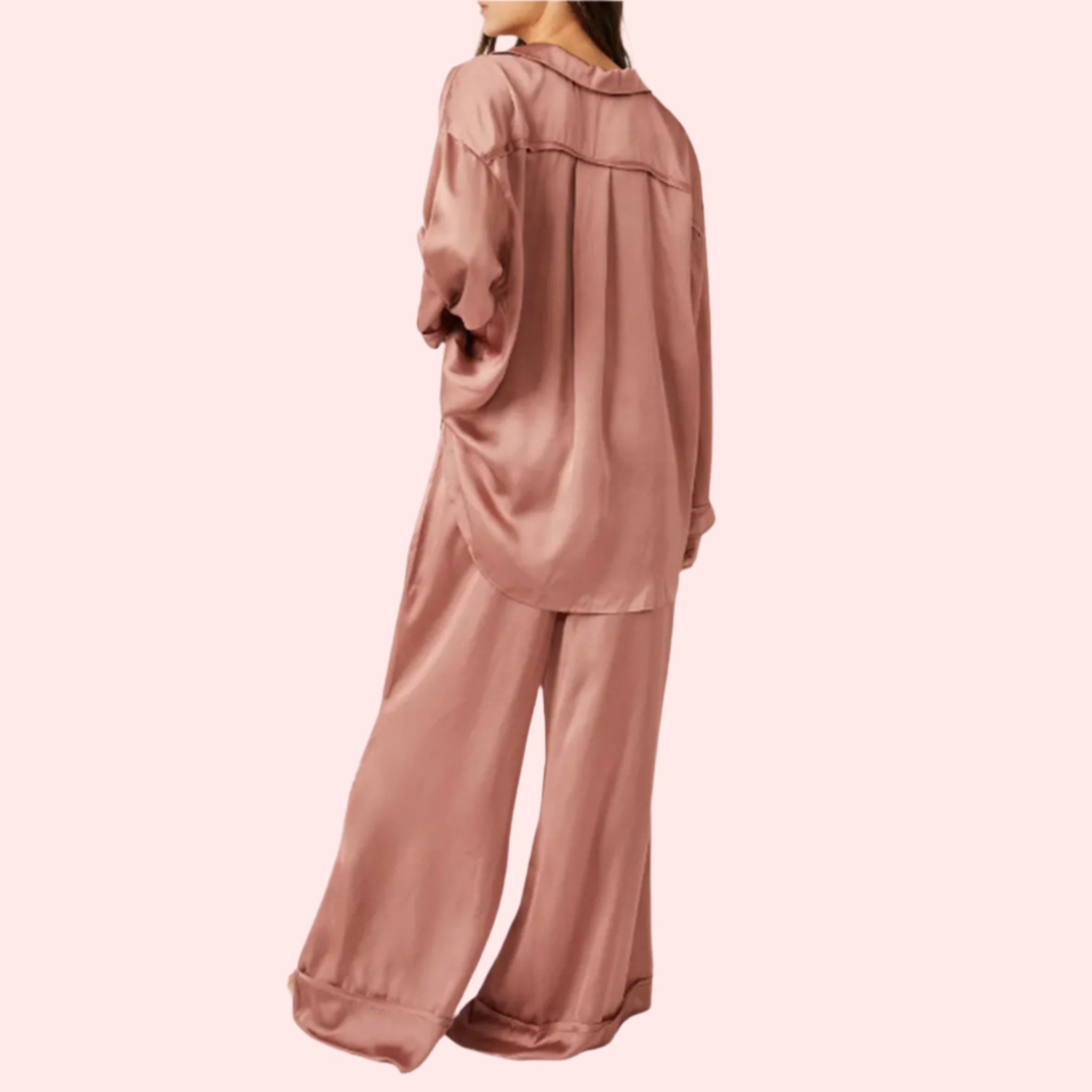 A model wearing an oversized slouchy fit pajama set in a rose gold color. 