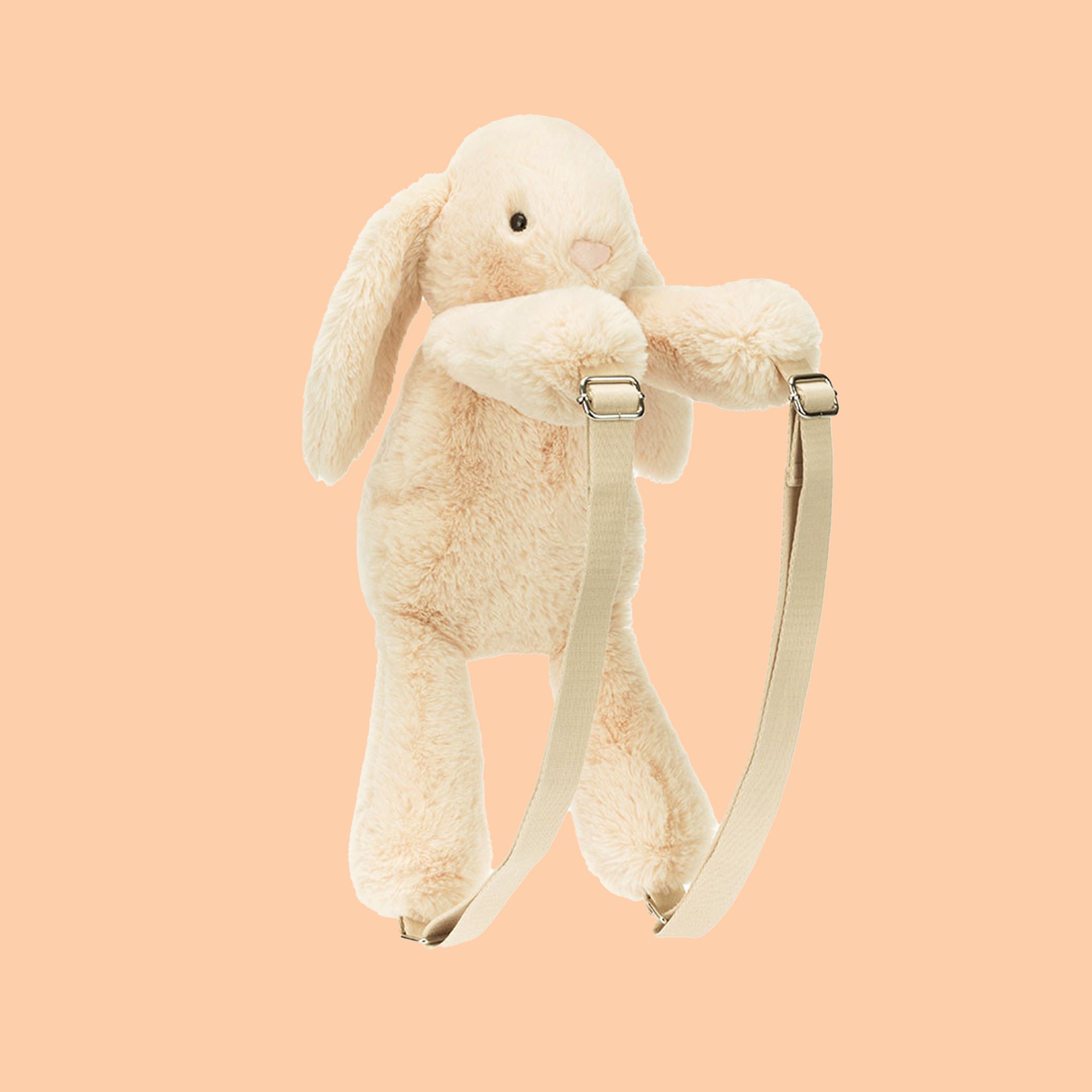 A neutral colored bunny shaped backpack. 