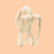 A neutral colored bunny shaped backpack. 