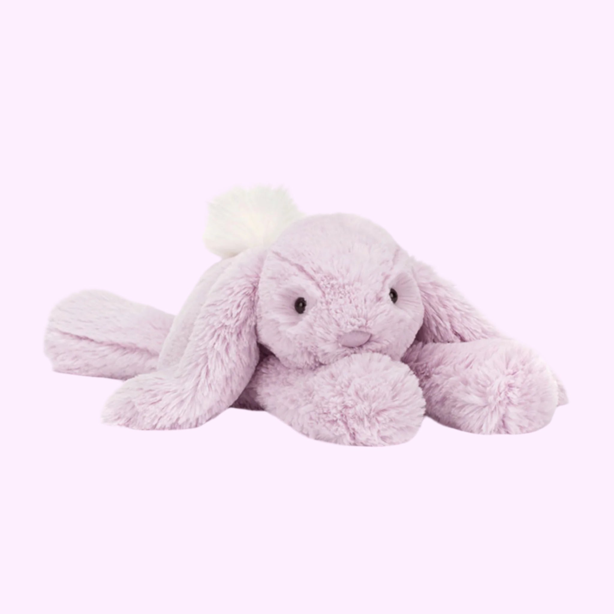 A purple rabbit shaped stuffed animal toy. 