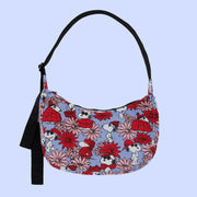 A blue and red floral and Snoopy print crescent shaped nylon handbag with a black adjustable logo strap. 