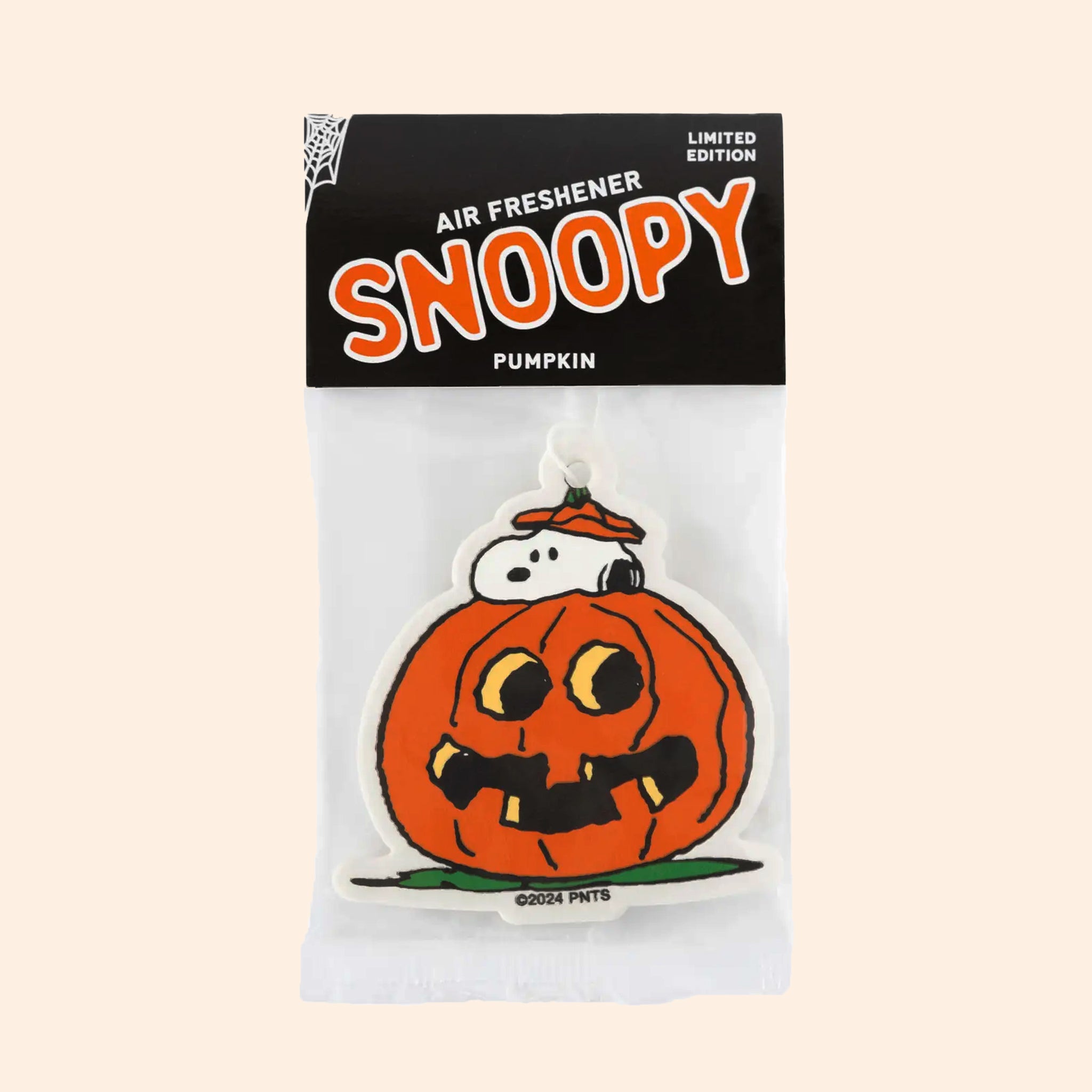 A pumpkin and snoopy shaped air freshener. 