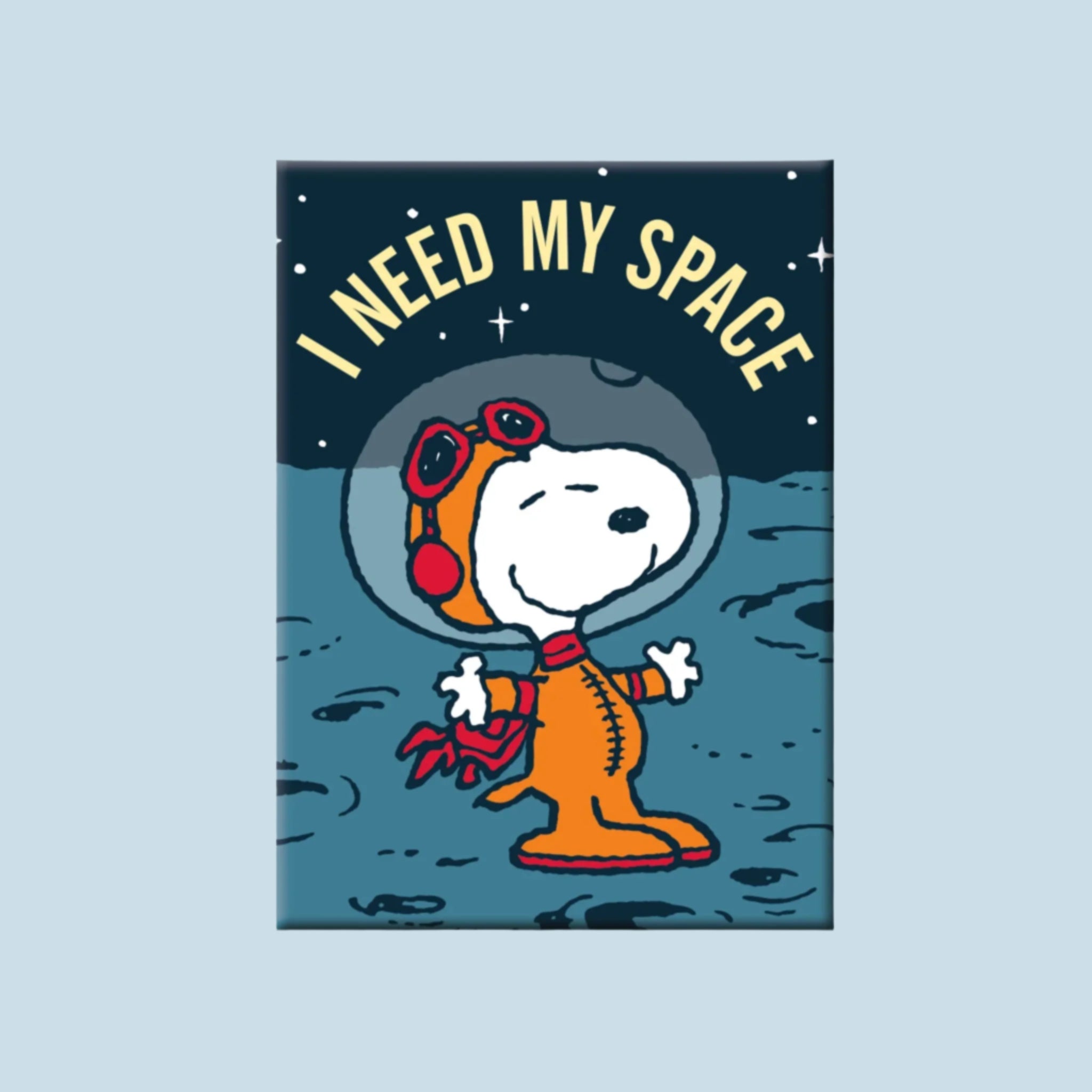 A dark blue magnet with an imagine of the character Snoopy in a spacesuit and text above that reads, 'I Need My Space'. 