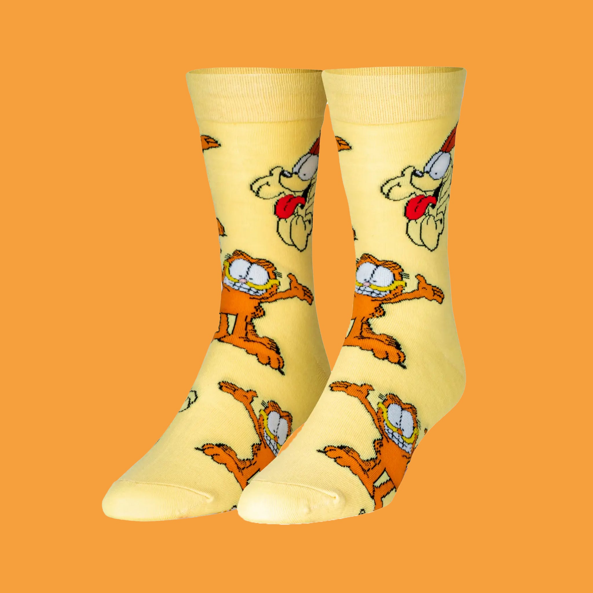 On an orange background is a yellow pair of socks with a garfield print.