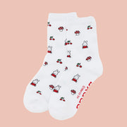A white pair of socks with a Miffy, mushroom and cherry print. 