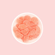 Pink colored watermelon slice shaped gummy candies. 