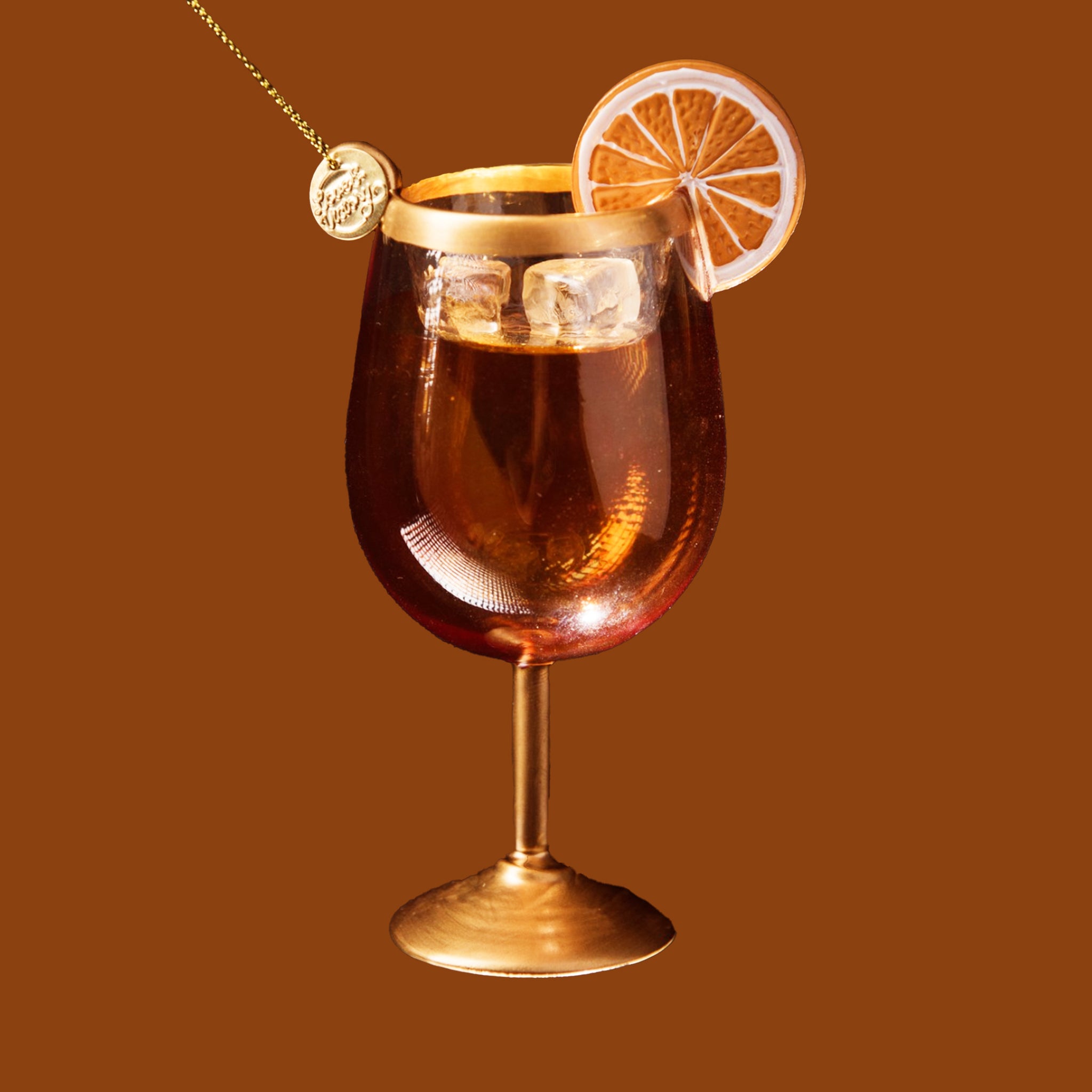 An orange and gold glass aperol spritz cocktail shaped ornament. 