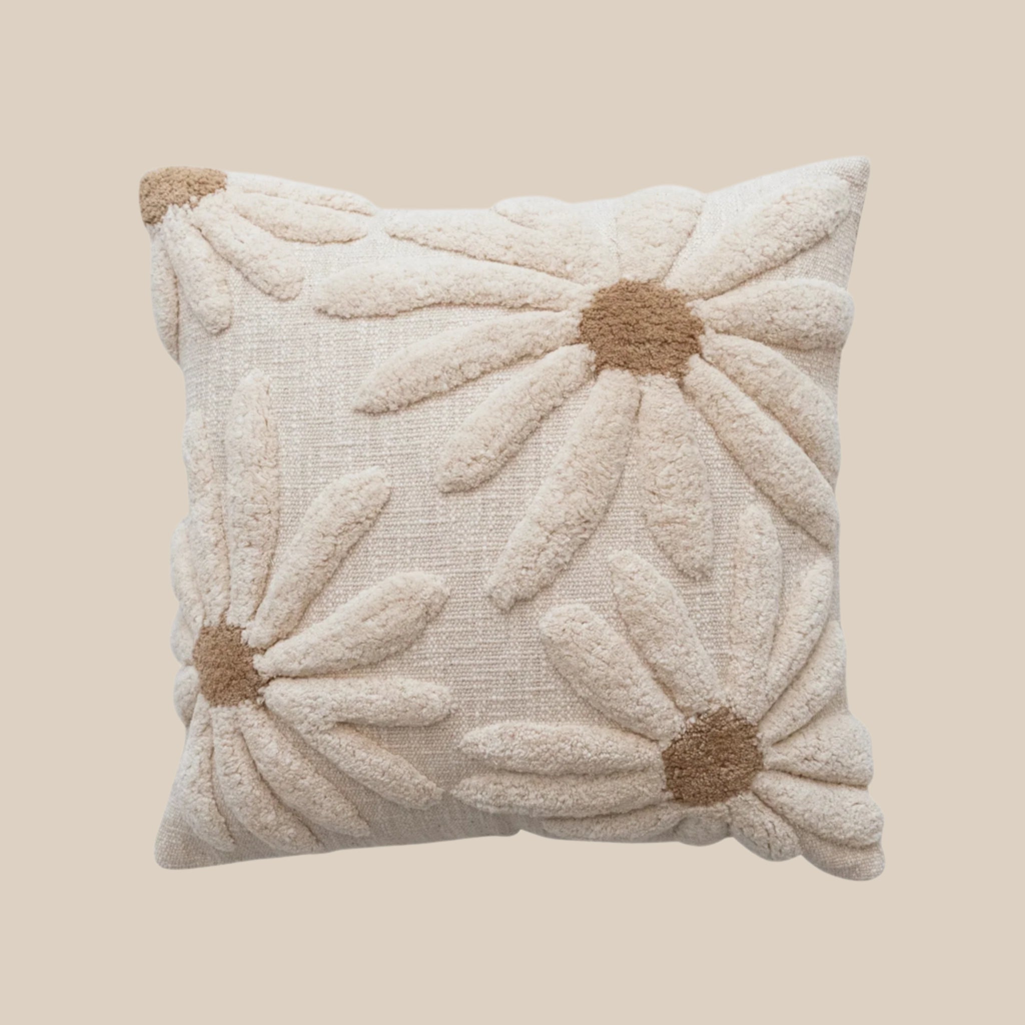 A neutral pillow with tufted flower designs. 