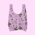 A pinkish purple nylon bag with a cactus and spike graphic print all over.