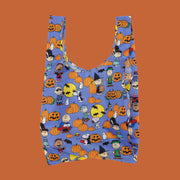 A purple reusable nylon bag with a charlie brown pumpkin patch pattern all over. 