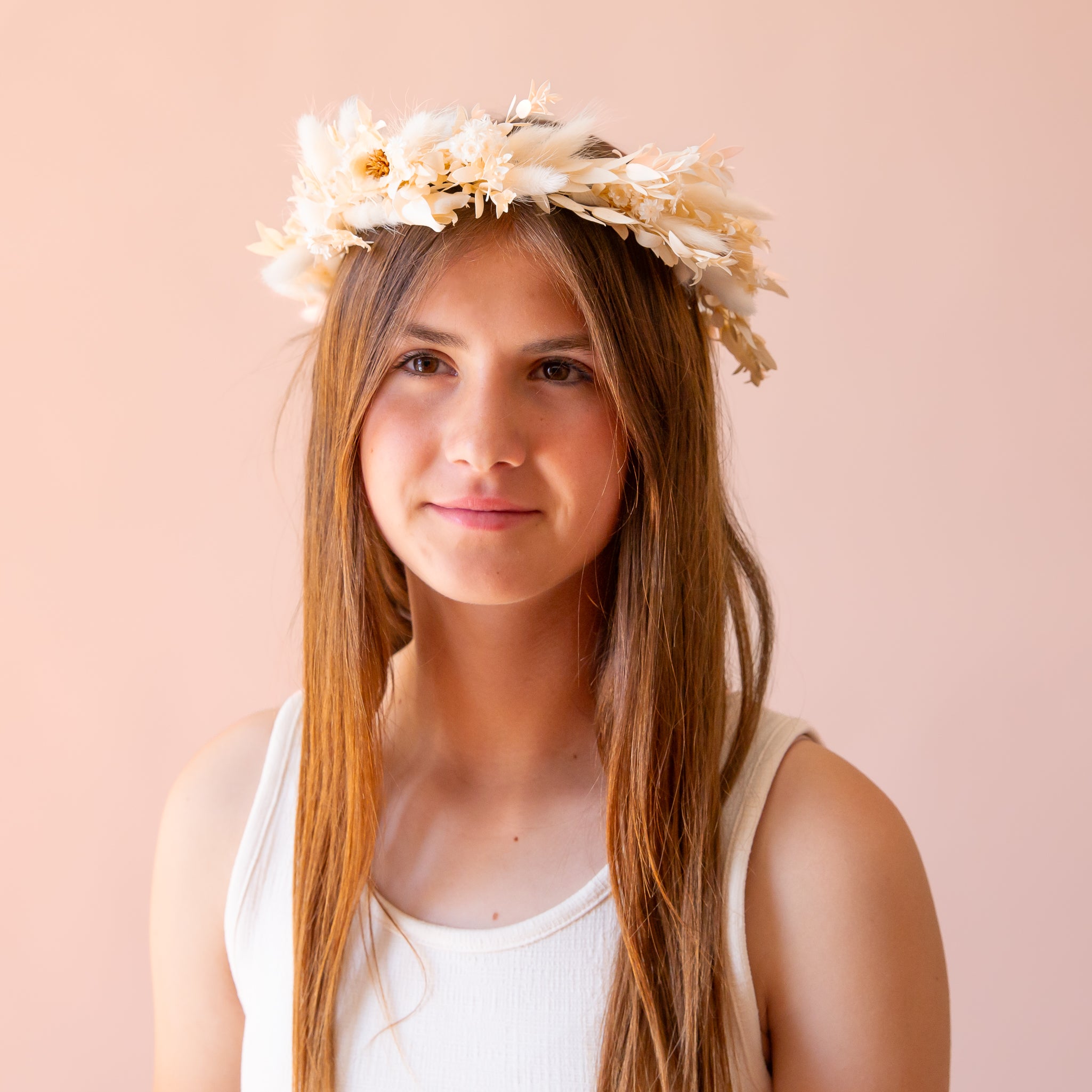 A flower crown made up of neutral dried florals and a tie detail at the back.