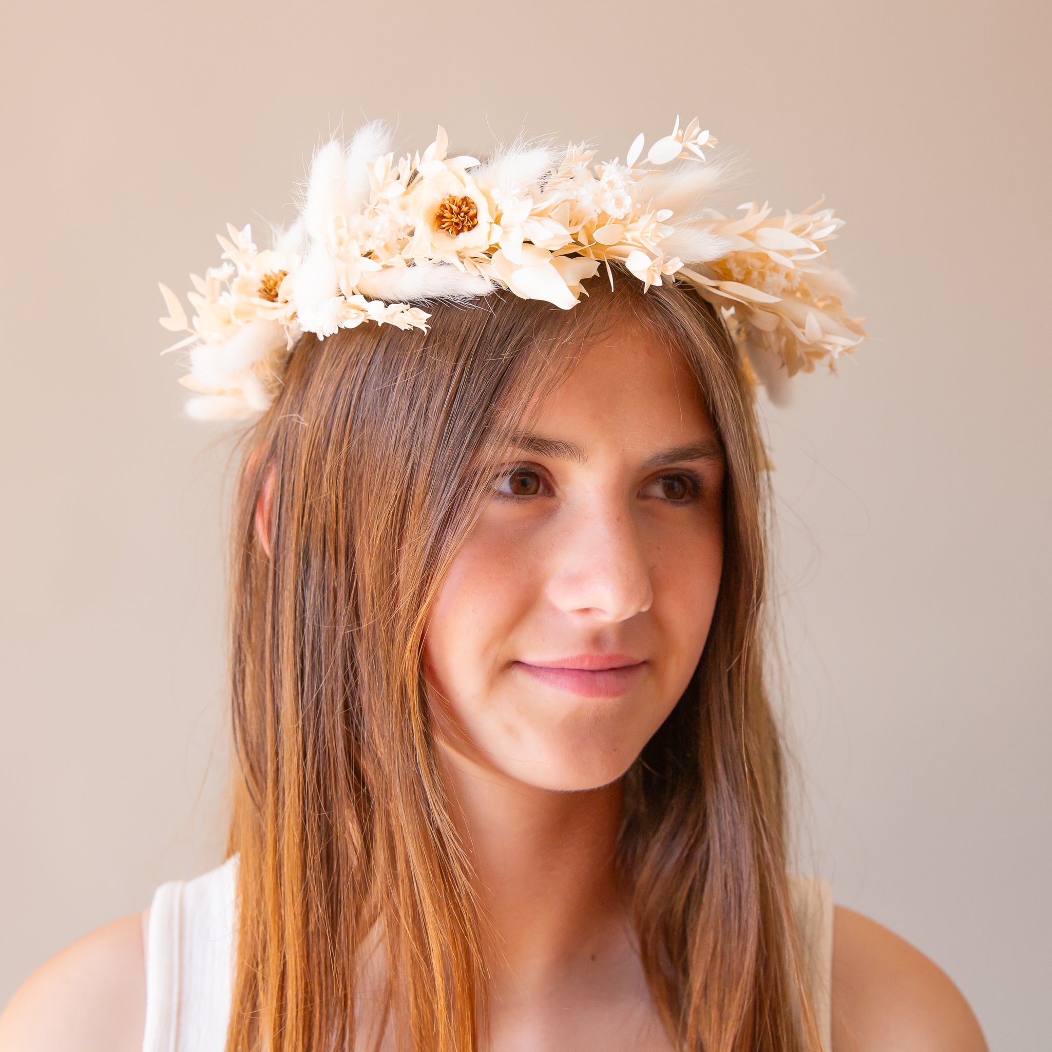 A flower crown made up of neutral dried florals and a tie detail at the back.