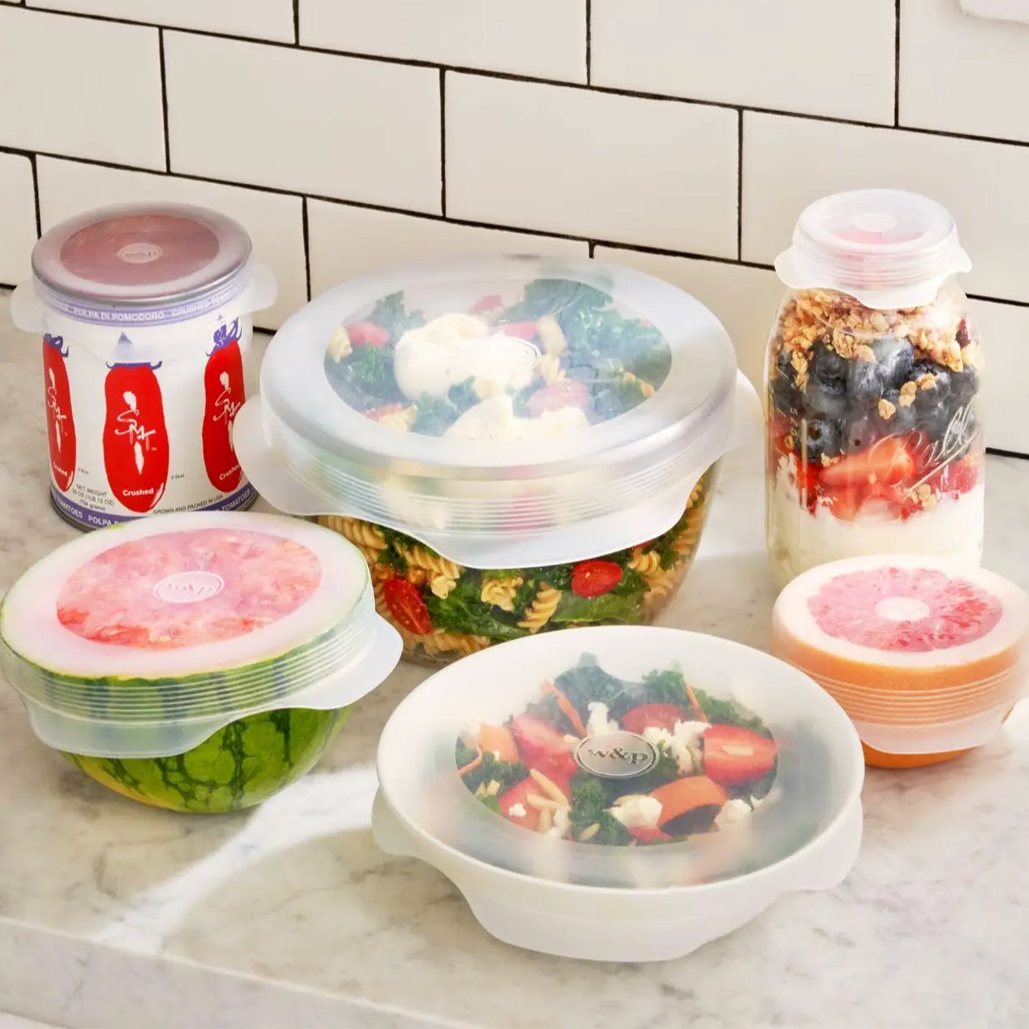 A set of six, round silicone stretch lids for storing food in the kitchen. Glasses used for the photo not included with purchase. 