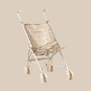 A stroller for baby doll toys with a neutral leopard print. 