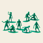A set of green tiny toys shaped as different surfers. 
