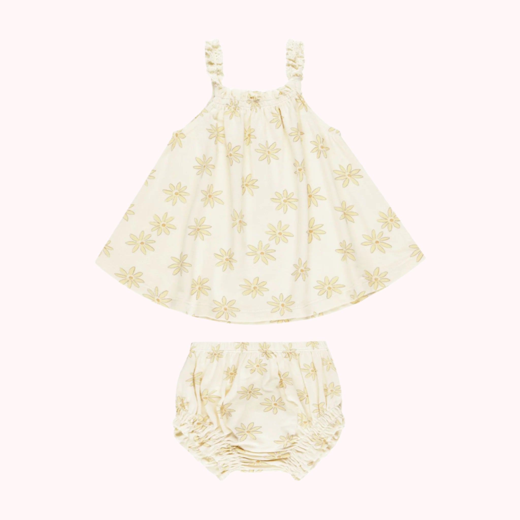 A cream set with a flowey top and bloomer bottoms with a light yellow daisy print. 