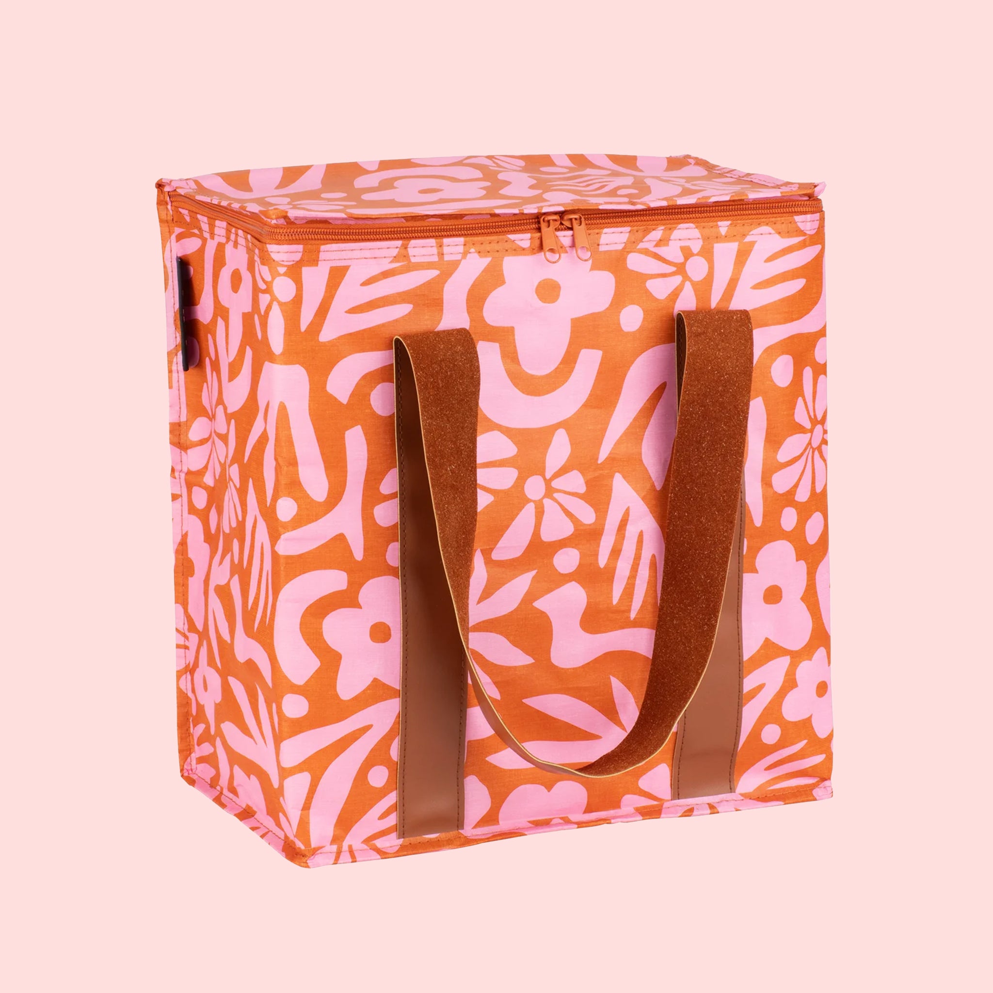 A pink and orange floral print cooler bag. 