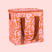 A pink and orange floral print cooler bag. 