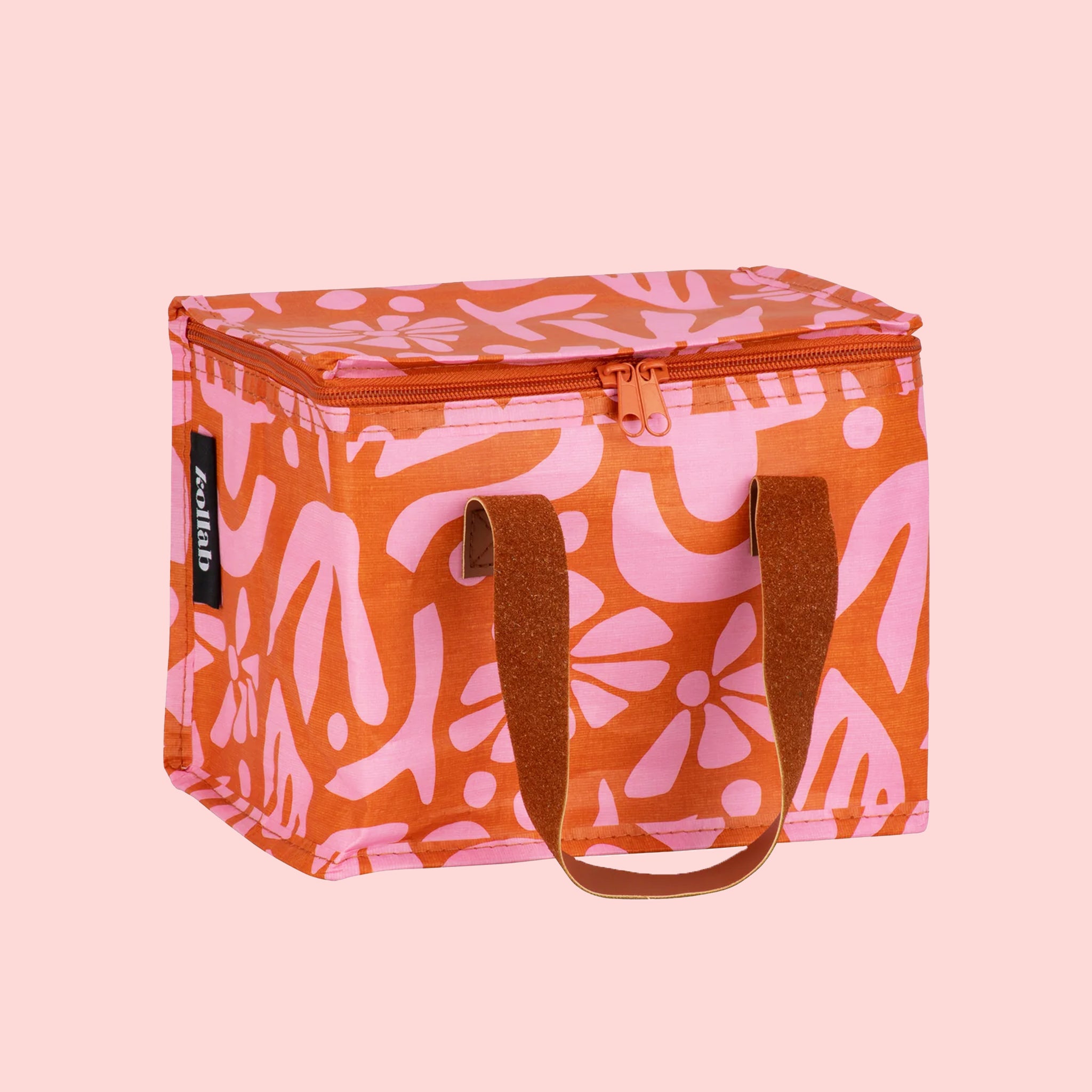 An orange and pink floral print lunch box with faux leather handles.