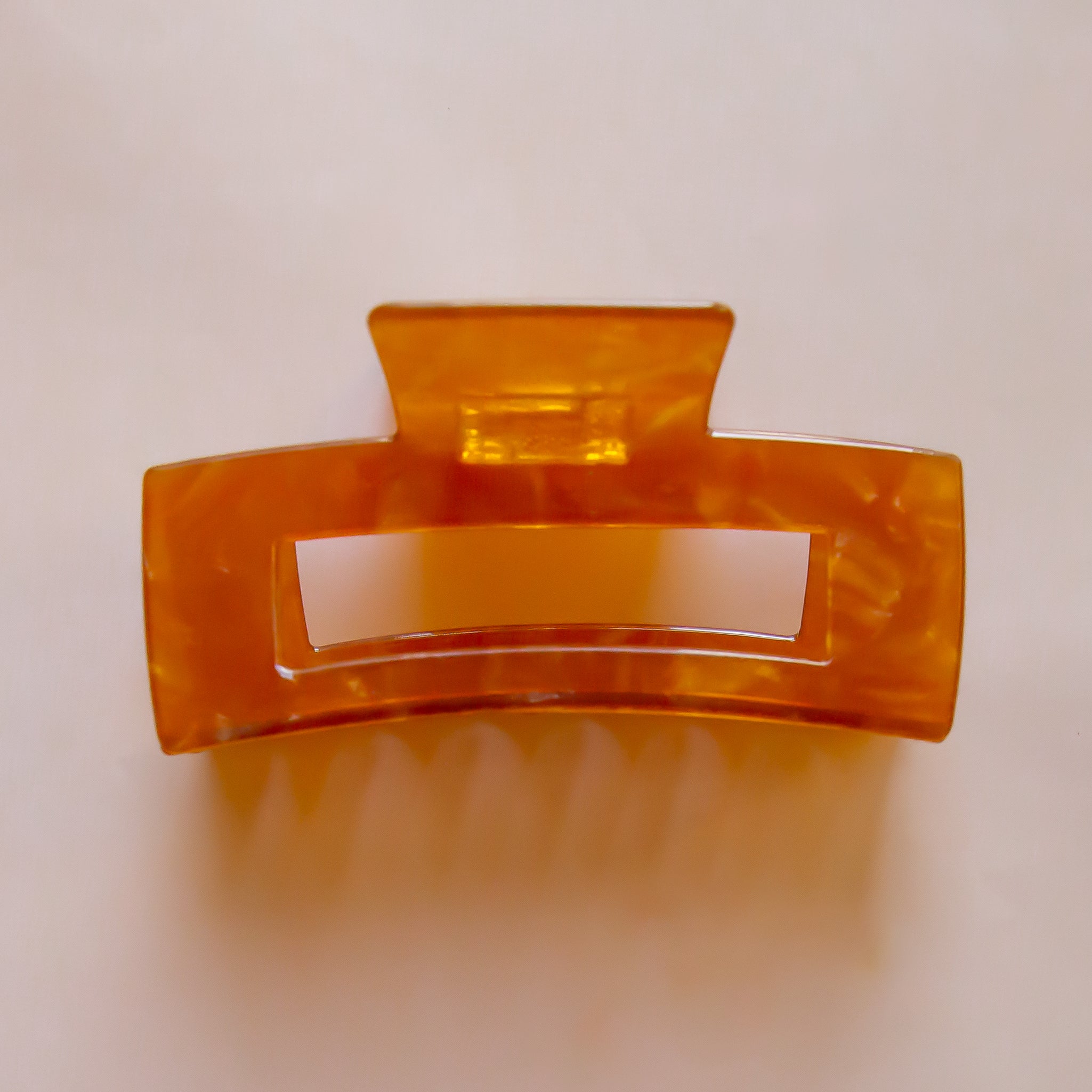 A brownish orange rectangle hair clip. 