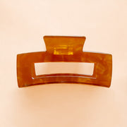 A brownish orange rectangle hair clip. 