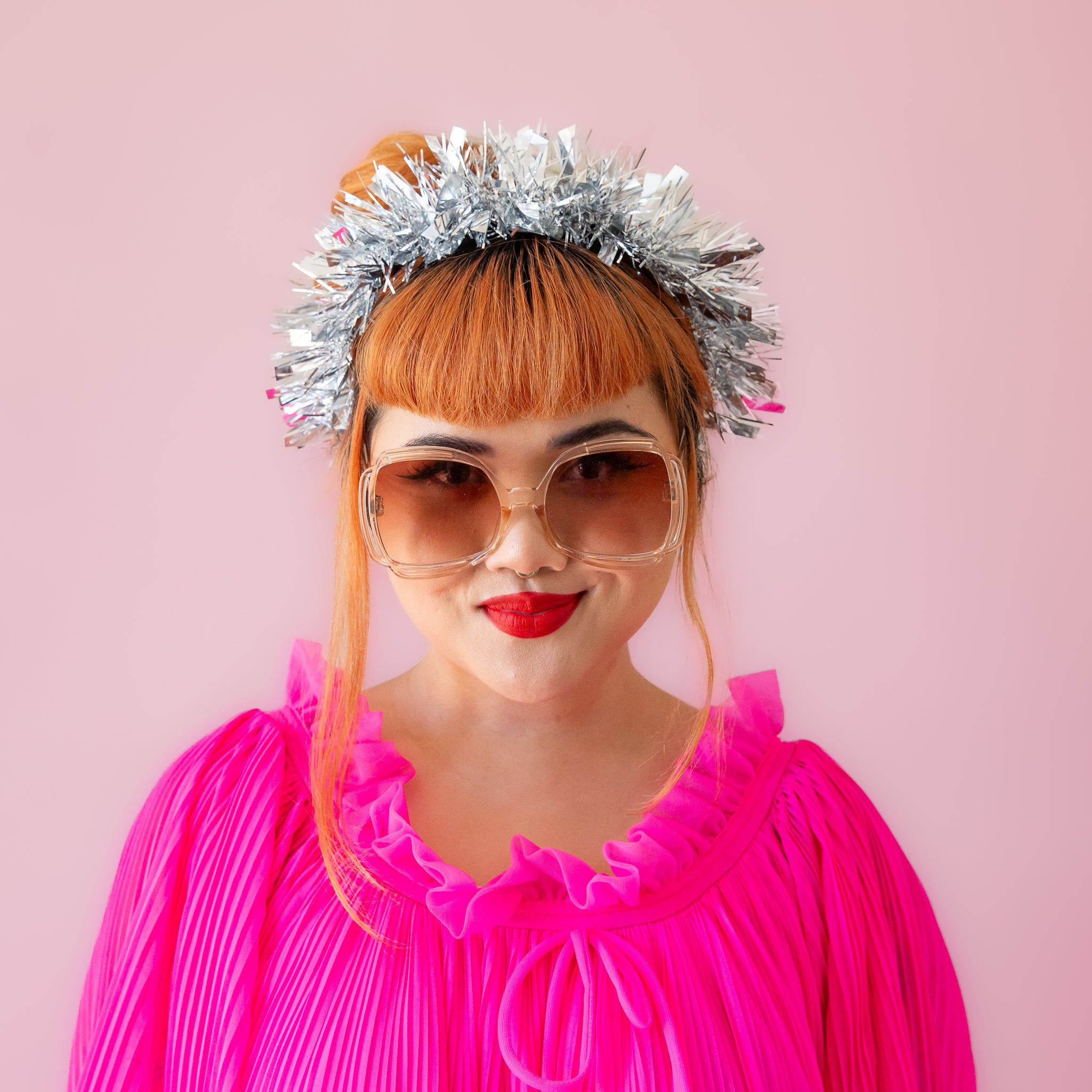 A model wearing a silver tinsel headband. 