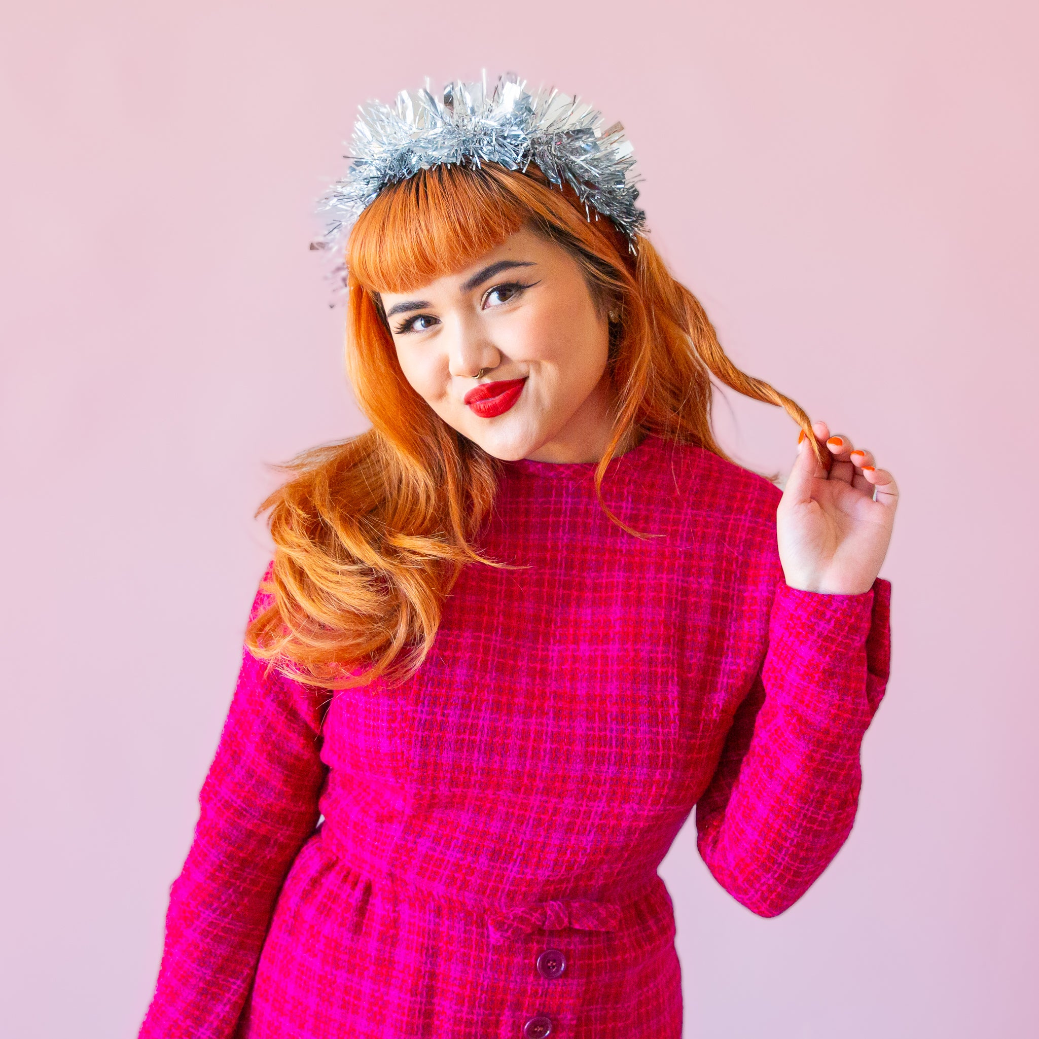 A model wearing a silver tinsel headband. 