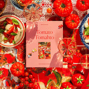 A light pink box filled with a tomato themed puzzle with beautiful red hues and imagery. 