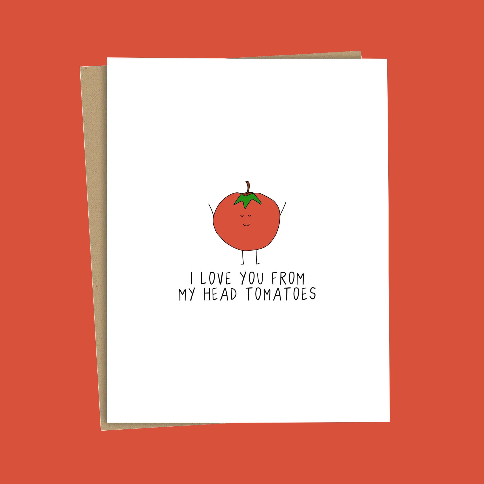 A white card with a red illustration of a tomato with black text that reads, 'I love you from my head tomatoes'. 